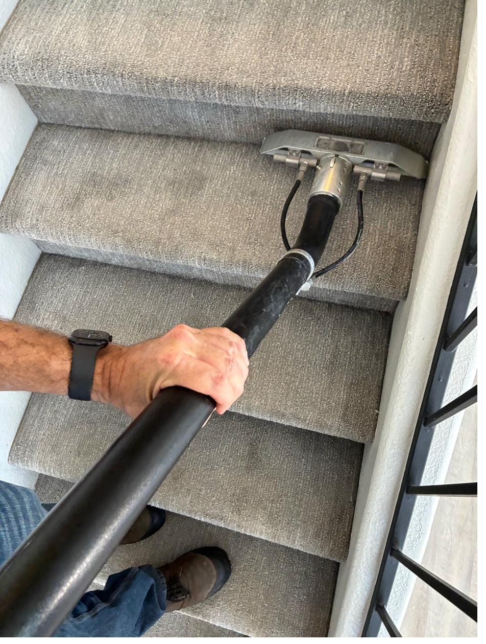 Carpet cleaning on a stairway, half cleaned