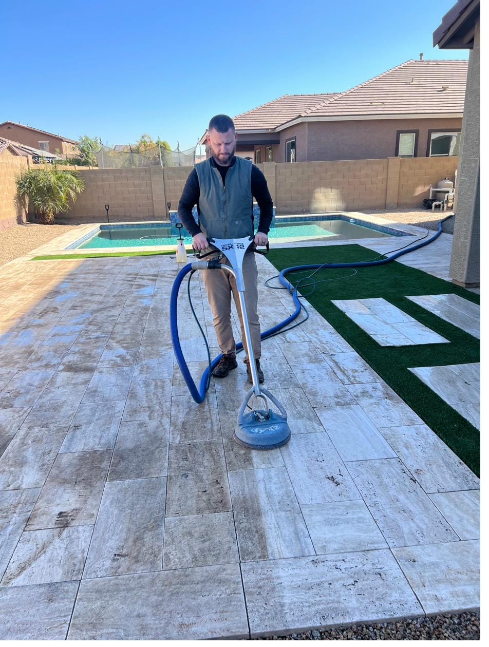 Stephan cleaning an outdoor travertine tile patio with the spinner tool