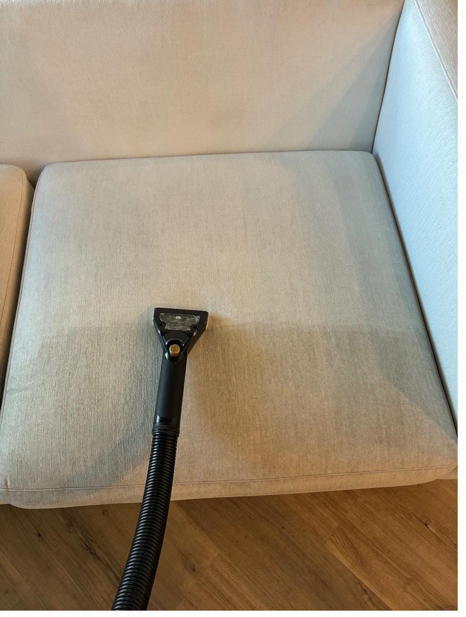 Upholstery cleaning showing the clean line on a sofa cushion